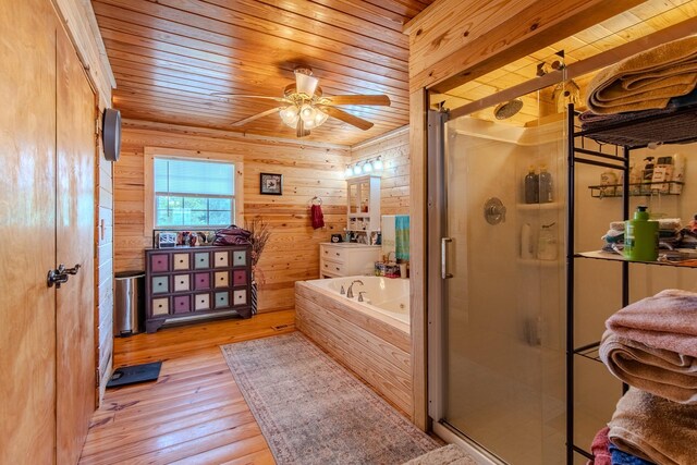 230 Silver Water Ln, Counce, TN 38326 - full bathroom with wooden ceiling, a stall shower, a tub with jets, wood finished floors, and a ceiling fan
