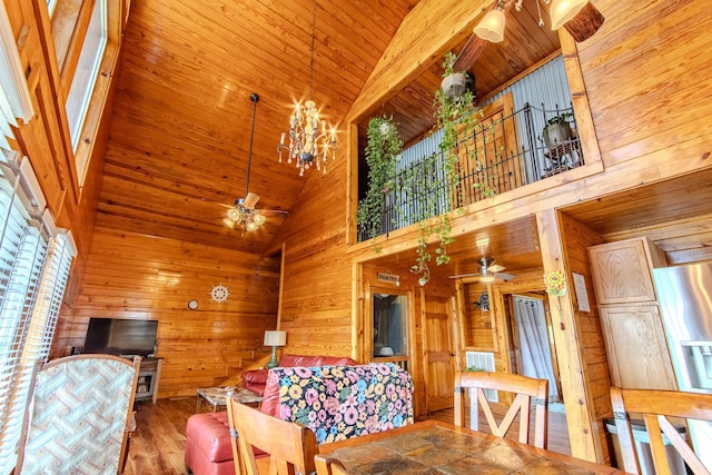 230 Silver Water Ln, Counce, TN 38326 - living room featuring a ceiling fan, high vaulted ceiling, wooden walls, wooden ceiling, and a chandelier