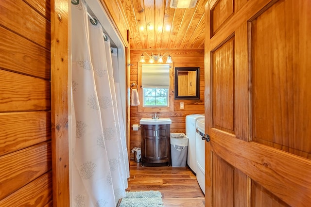 230 Silver Water Ln, Counce, TN 38326 - full bathroom with independent washer and dryer, wooden ceiling, wood finished floors, wooden walls, and vanity