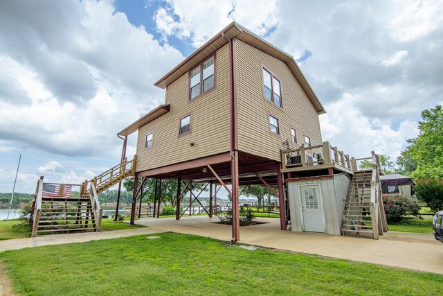 230 Silver Water Ln, Counce, TN 38326 - surrounding community with stairs, a deck, a lawn, and a carport
