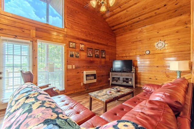 230 Silver Water Ln, Counce, TN 38326 - living room featuring vaulted ceiling, wood walls, heating unit, a ceiling fan, and wooden ceiling