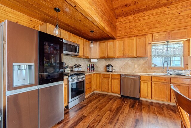 230 Silver Water Ln, Counce, TN 38326 - kitchen with appliances with stainless steel finishes, backsplash, light countertops, a sink, and dark wood finished floors