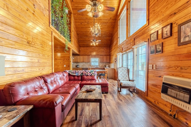 230 Silver Water Ln, Counce, TN 38326 - living room featuring a ceiling fan, heating unit, high vaulted ceiling, wooden walls, and wood finished floors