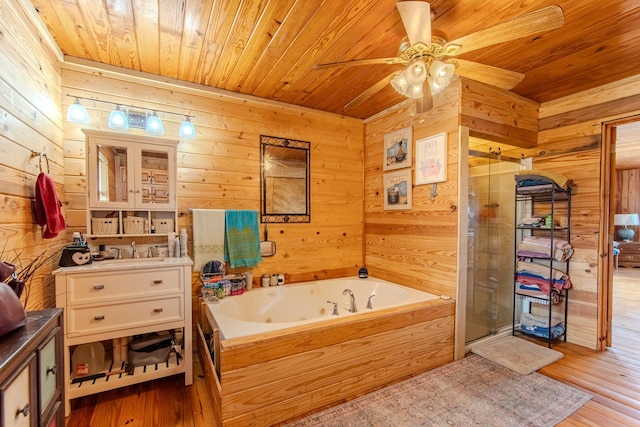 230 Silver Water Ln, Counce, TN 38326 - bathroom featuring wooden ceiling, wooden walls, vanity, a stall shower, and ceiling fan