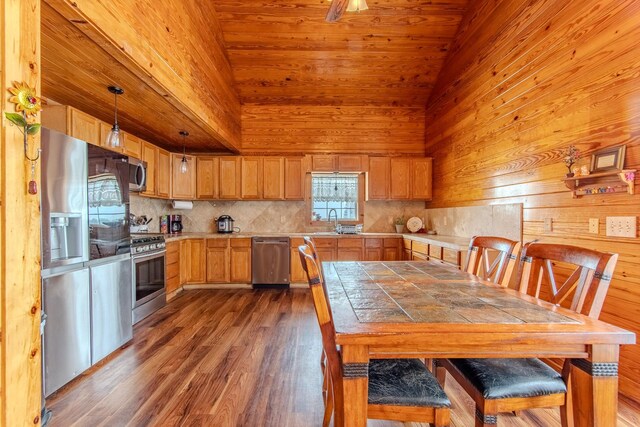 230 Silver Water Ln, Counce, TN 38326 - kitchen featuring appliances with stainless steel finishes, decorative backsplash, dark wood finished floors, a sink, and tile counters