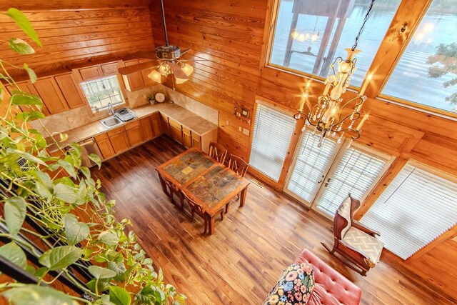 230 Silver Water Ln, Counce, TN 38326 - living room with wood walls, a chandelier, ceiling fan, and wood finished floors