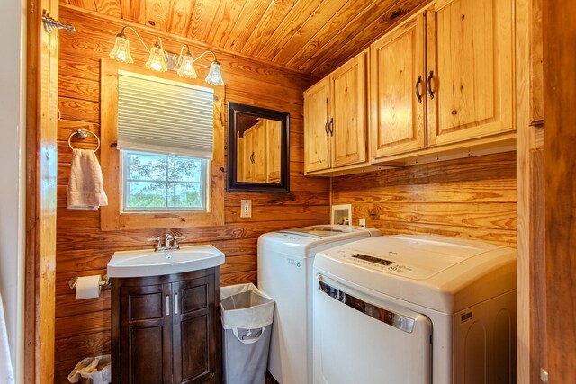 230 Silver Water Ln, Counce, TN 38326 - washroom with separate washer and dryer, cabinet space, wooden walls, and wooden ceiling