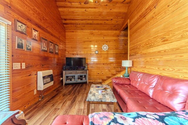 230 Silver Water Ln, Counce, TN 38326 - living area featuring heating unit, wooden walls, wood finished floors, and vaulted ceiling