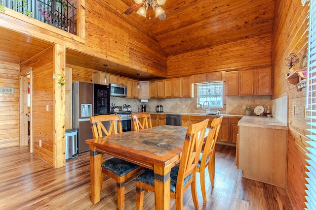 230 Silver Water Ln, Counce, TN 38326 - dining area with wood ceiling, light wood finished floors, high vaulted ceiling, ceiling fan, and wood walls