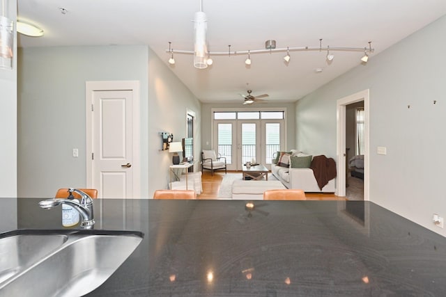 817 3rd Ave N Unit 411, Nashville, TN 37201 - kitchen featuring a sink, a ceiling fan, dark countertops, and track lighting