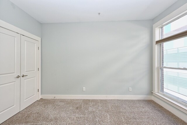 817 3rd Ave N Unit 411, Nashville, TN 37201 - unfurnished bedroom featuring carpet floors, baseboards, and a closet