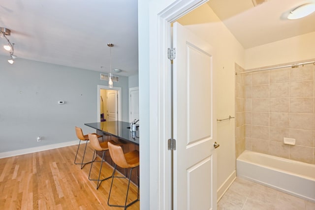 817 3rd Ave N Unit 411, Nashville, TN 37201 - full bathroom with bathing tub / shower combination, baseboards, and wood finished floors