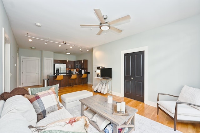 817 3rd Ave N Unit 411, Nashville, TN 37201 - living area with light wood-style floors, a ceiling fan, and baseboards