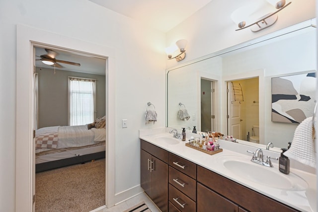 817 3rd Ave N Unit 411, Nashville, TN 37201 - ensuite bathroom with double vanity, toilet, a ceiling fan, and baseboards
