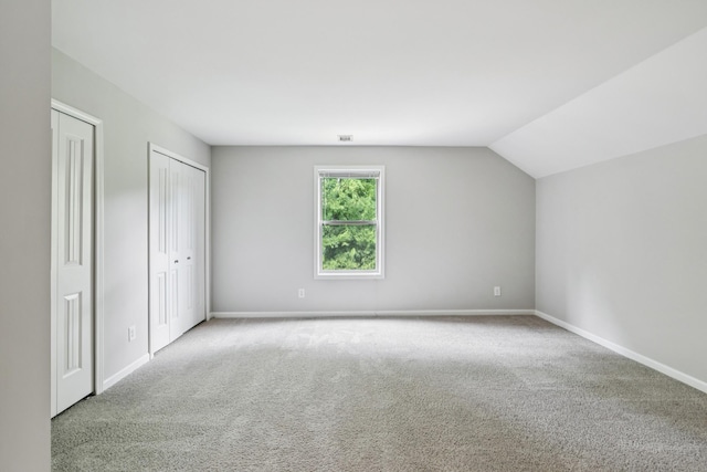 2040 Belshire Way, Spring Hill, TN 37174 - unfurnished bedroom with carpet flooring, multiple closets, lofted ceiling, and baseboards