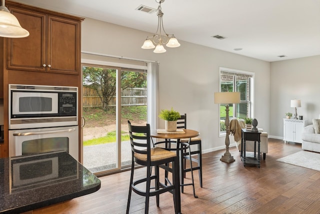 2040 Belshire Way, Spring Hill, TN 37174 - dining room with wood finished floors, a chandelier, and baseboards