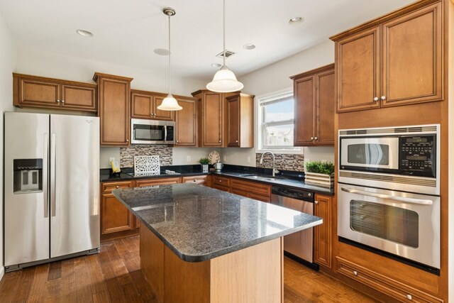 2040 Belshire Way, Spring Hill, TN 37174 - kitchen with appliances with stainless steel finishes, a sink, brown cabinetry, a center island, and recessed lighting