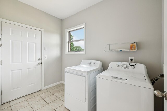 2040 Belshire Way, Spring Hill, TN 37174 - washroom with washing machine and clothes dryer, baseboards, and light tile patterned floors