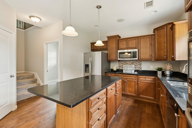 2040 Belshire Way, Spring Hill, TN 37174 - kitchen with stainless steel appliances, dark wood-type flooring, brown cabinetry, and a sink