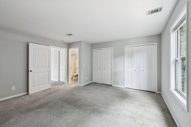 2040 Belshire Way, Spring Hill, TN 37174 - unfurnished bedroom with multiple closets, multiple windows, and carpet floors