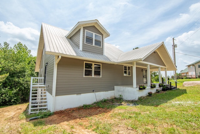 619 Bridgeview Cv, Bath Springs, TN 38311 - view of front of property with metal roof, crawl space, a porch, and a front yard