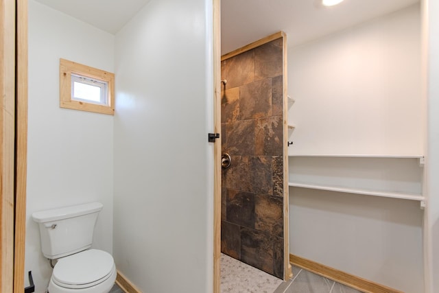 619 Bridgeview Cv, Bath Springs, TN 38311 - full bathroom featuring a tile shower, toilet, and baseboards