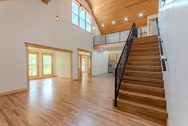 619 Bridgeview Cv, Bath Springs, TN 38311 - staircase with high vaulted ceiling, plenty of natural light, wood finished floors, baseboards, and wooden ceiling
