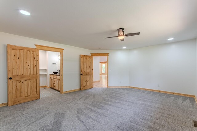 619 Bridgeview Cv, Bath Springs, TN 38311 - unfurnished bedroom featuring light colored carpet, baseboards, recessed lighting, ensuite bath, and a ceiling fan