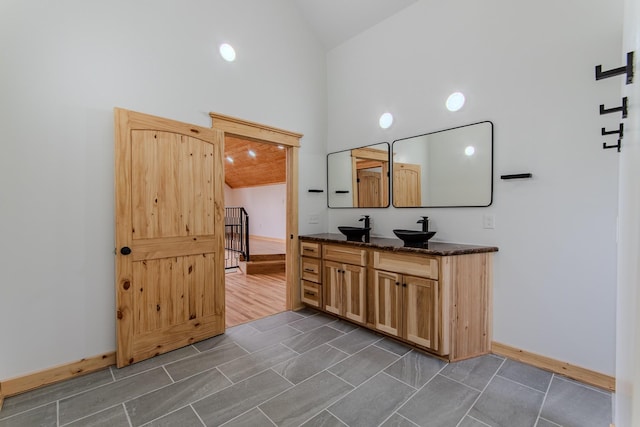 619 Bridgeview Cv, Bath Springs, TN 38311 - full bathroom with high vaulted ceiling, double vanity, and baseboards