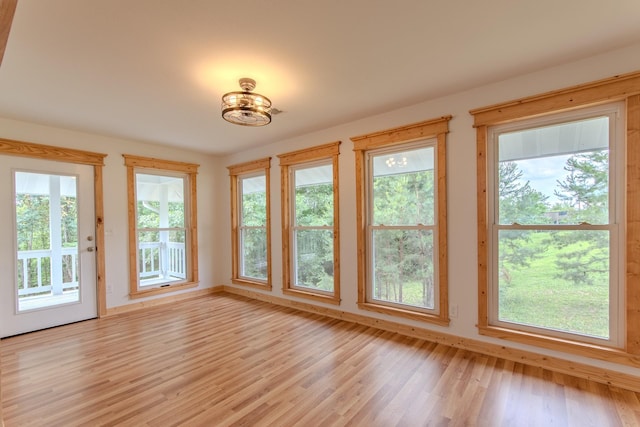 619 Bridgeview Cv, Bath Springs, TN 38311 - unfurnished sunroom with plenty of natural light, wood finished floors, and baseboards