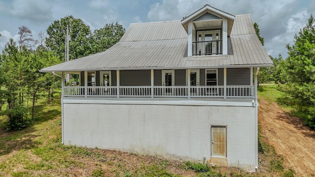 619 Bridgeview Cv, Bath Springs, TN 38311 - view of front of property featuring metal roof, covered porch, and a balcony