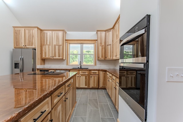 619 Bridgeview Cv, Bath Springs, TN 38311 - kitchen featuring appliances with stainless steel finishes, light brown cabinets, a sink, and dark stone counters