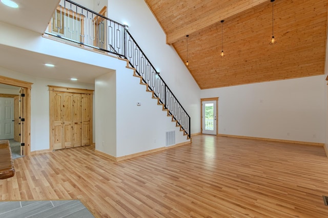 619 Bridgeview Cv, Bath Springs, TN 38311 - unfurnished living room with high vaulted ceiling, wood finished floors, stairs, baseboards, and recessed lighting