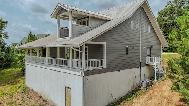 619 Bridgeview Cv, Bath Springs, TN 38311 - view of property exterior with metal roof, stairway, and central AC unit