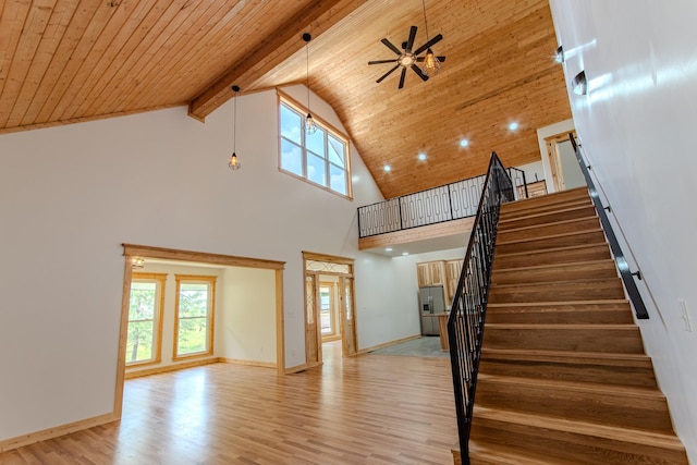 619 Bridgeview Cv, Bath Springs, TN 38311 - unfurnished living room with high vaulted ceiling, light wood finished floors, ceiling fan, stairway, and wooden ceiling with exposed beams