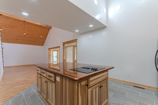 619 Bridgeview Cv, Bath Springs, TN 38311 - kitchen with black electric stovetop, baseboards, light tile patterned flooring, dark stone countertops, and recessed lighting