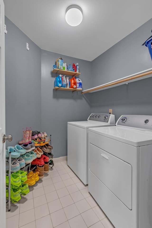 1305 Standing Stone Cir, Columbia, TN 38401 - washroom featuring washing machine and clothes dryer, light tile patterned floors, and baseboards