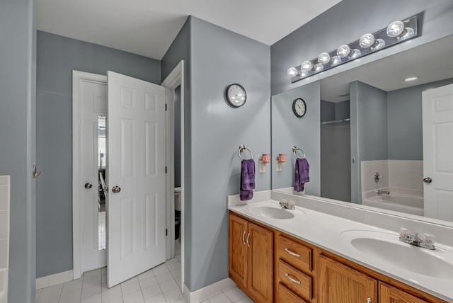 1305 Standing Stone Cir, Columbia, TN 38401 - bathroom featuring a garden tub, baseboards, toilet, and double vanity