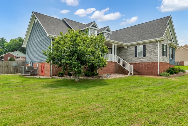 1305 Standing Stone Cir, Columbia, TN 38401 - rear view of property featuring a shingled roof, stairway, and stone siding