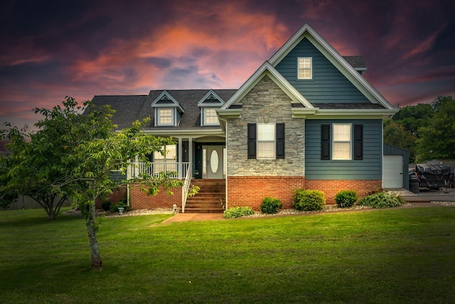 1305 Standing Stone Cir, Columbia, TN 38401 - view of front of house with a lawn, covered porch, stone siding, and stairs