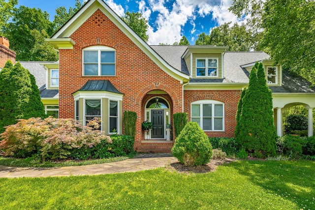 9542 Legacy Oaks Dr, Ooltewah, TN 37363 - view of front of property featuring brick siding, a front lawn, and a shingled roof