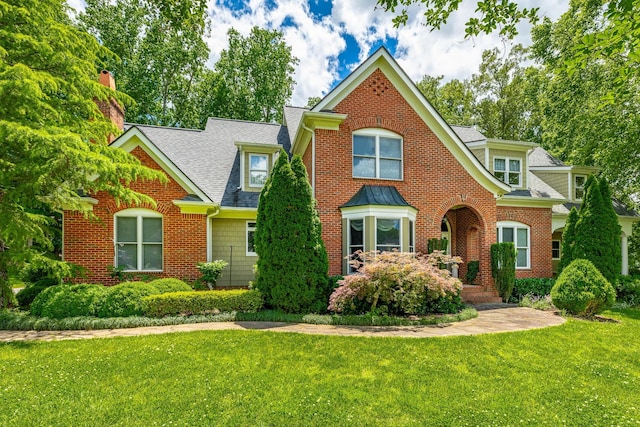 9542 Legacy Oaks Dr, Ooltewah, TN 37363 - view of front facade with a shingled roof, a front yard, and a chimney