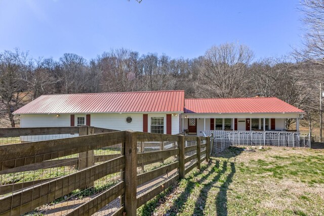 5312 Wiley Hollow Rd, Culleoka, TN 38451 - ranch-style home featuring metal roof, covered porch, and a view of trees