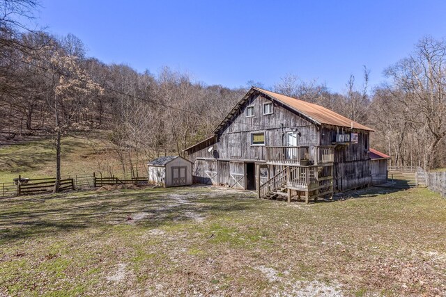 5312 Wiley Hollow Rd, Culleoka, TN 38451 - back of house featuring a barn and a view of trees