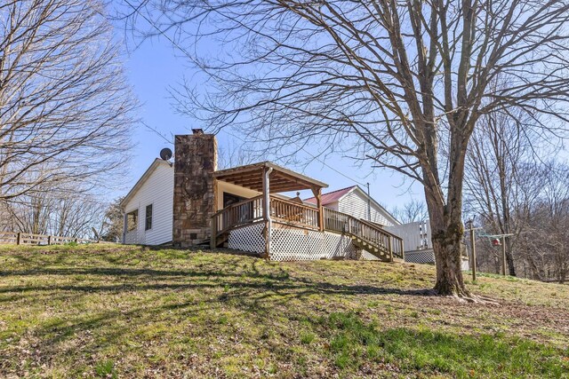 5312 Wiley Hollow Rd, Culleoka, TN 38451 - rear view of property featuring a deck, a chimney, stairway, and a yard