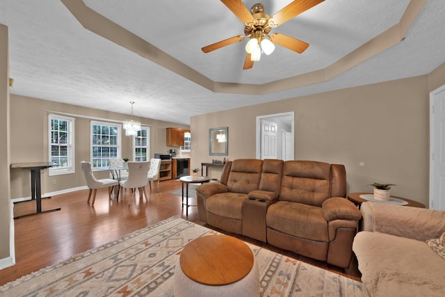 2879 Chinquapin Ln, Clarksville, TN 37043 - living room featuring light wood finished floors, a chandelier, ceiling fan, baseboards, and a textured ceiling