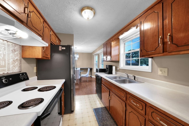 2879 Chinquapin Ln, Clarksville, TN 37043 - kitchen featuring range with electric cooktop, a sink, light floors, under cabinet range hood, and black dishwasher