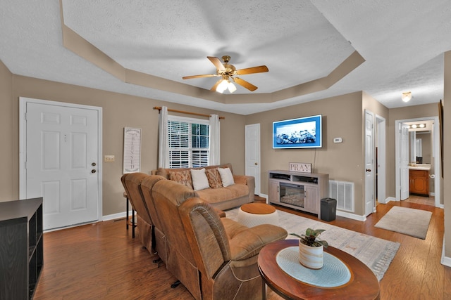2879 Chinquapin Ln, Clarksville, TN 37043 - living room with a textured ceiling, a raised ceiling, baseboards, ceiling fan, and wood finished floors