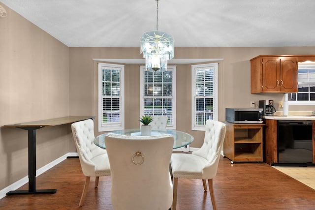 2879 Chinquapin Ln, Clarksville, TN 37043 - dining room featuring baseboards, a chandelier, light wood-style flooring, and healthy amount of natural light