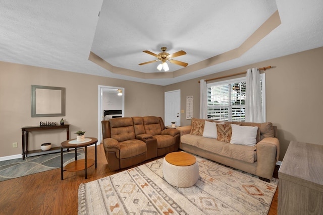 2879 Chinquapin Ln, Clarksville, TN 37043 - living area with ceiling fan, a tray ceiling, wood finished floors, baseboards, and a textured ceiling